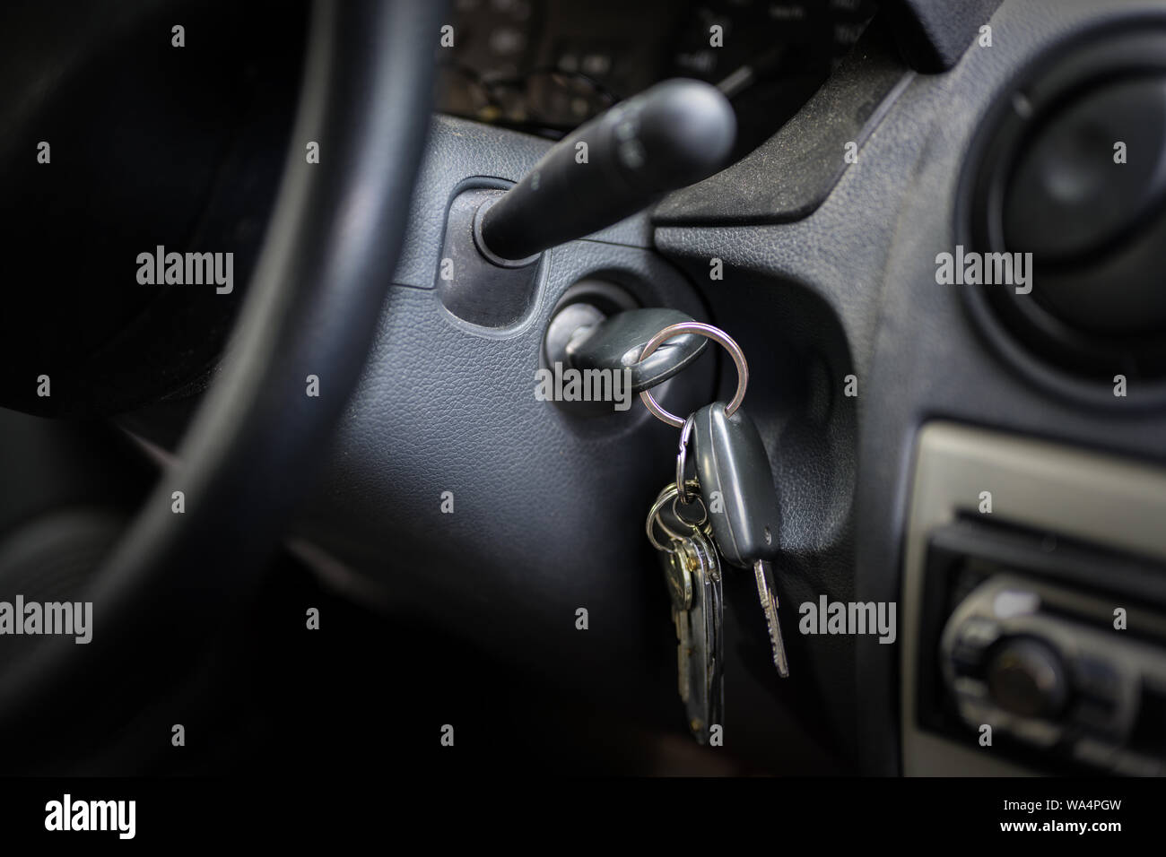 ignition key in the lock of an older car, selected focus, narrow depth of field Stock Photo