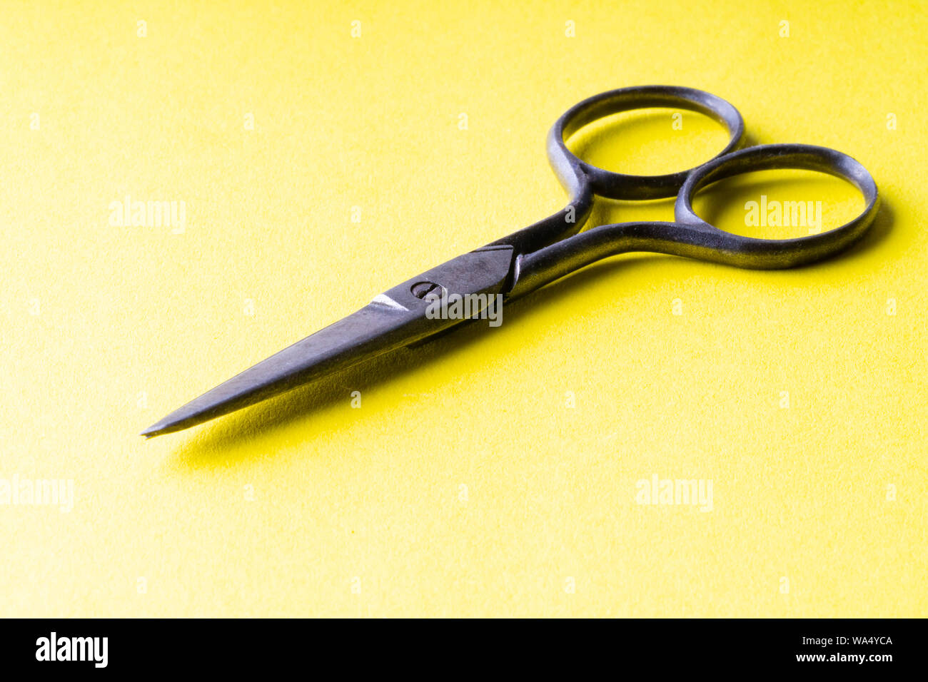 vintage scissors on a yellow background Stock Photo