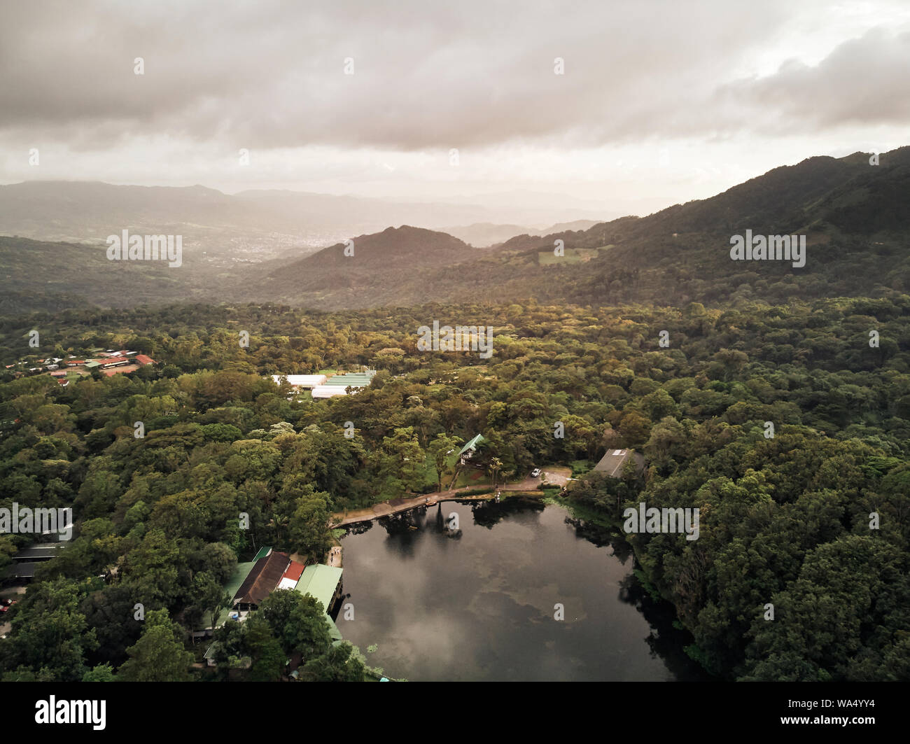 Lake on agricultural farm on mountain valley aerial drone view Stock Photo