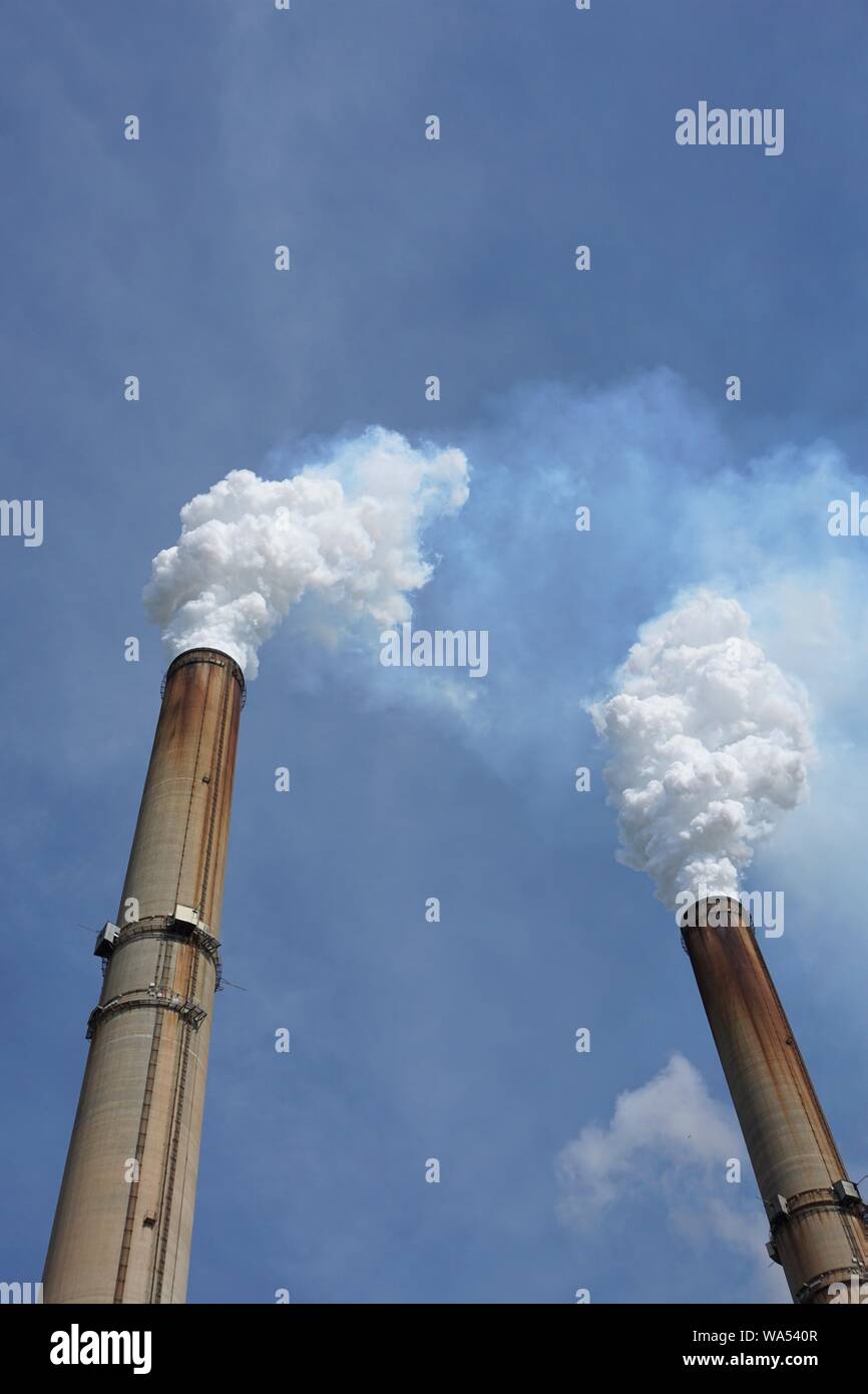 Smoke stacks from a coal-burning power plant -  vertical Stock Photo