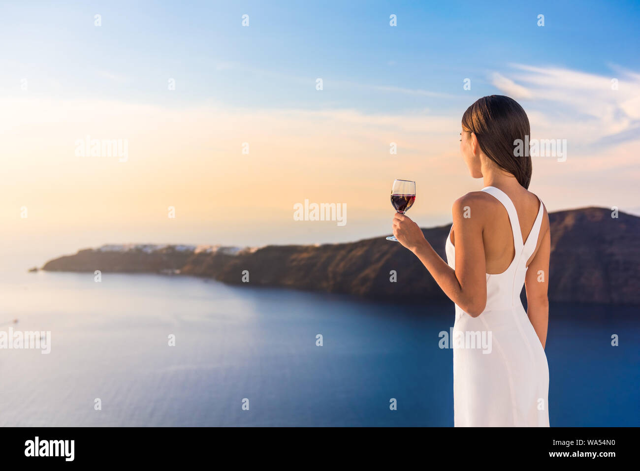 Woman watching sunset balcony hi-res stock photography and images - Alamy