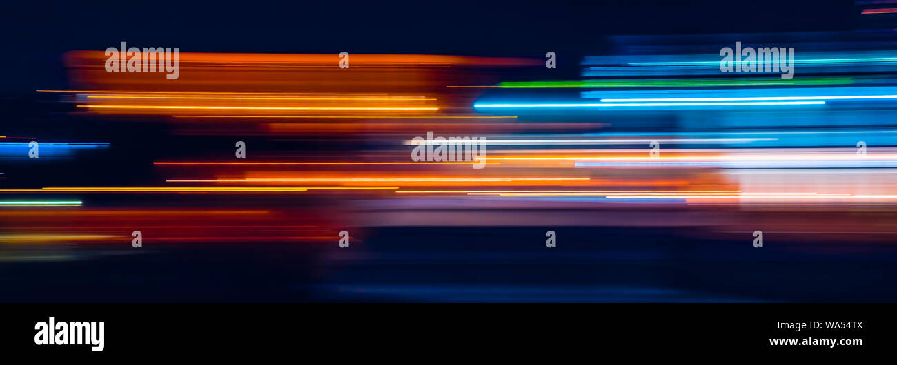 Abstract Rainbow light trails on the dark background Stock Photo - Alamy