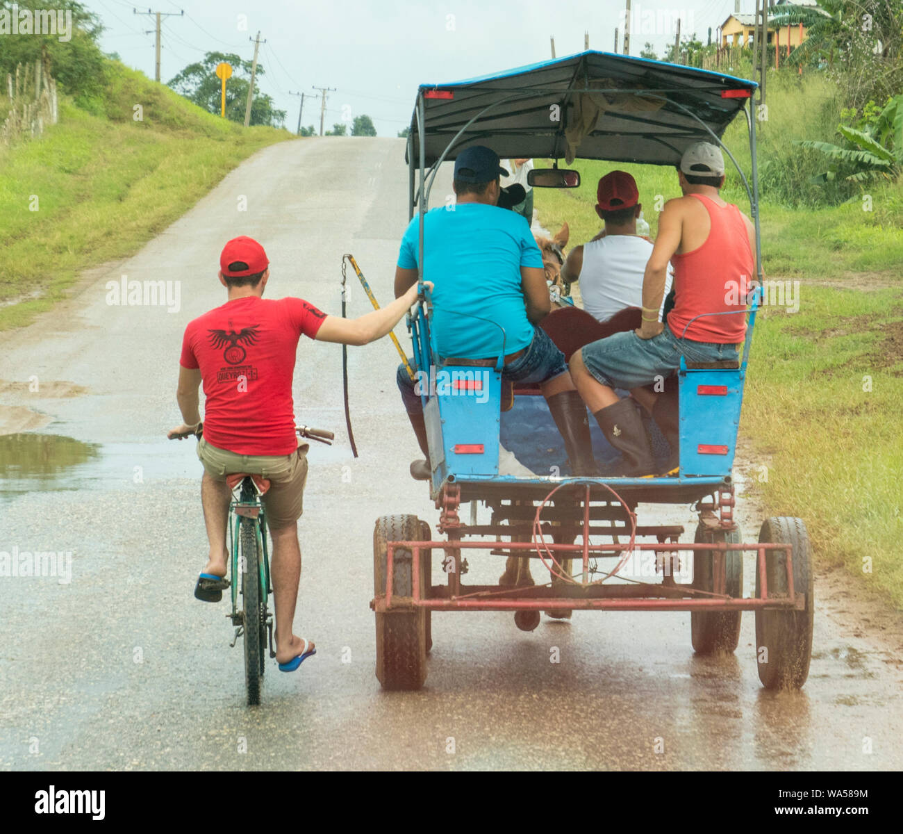 Trinidad, Cuba, Nov 26, 2017 Man on bicycle hitches ride on horse