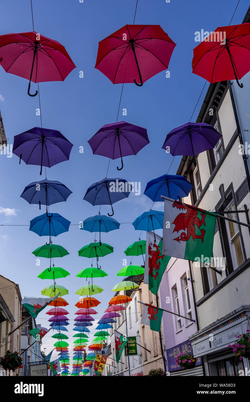 Multi-coloured umbrellas over Palace Street, Caernarfon, North Wales Stock Photo