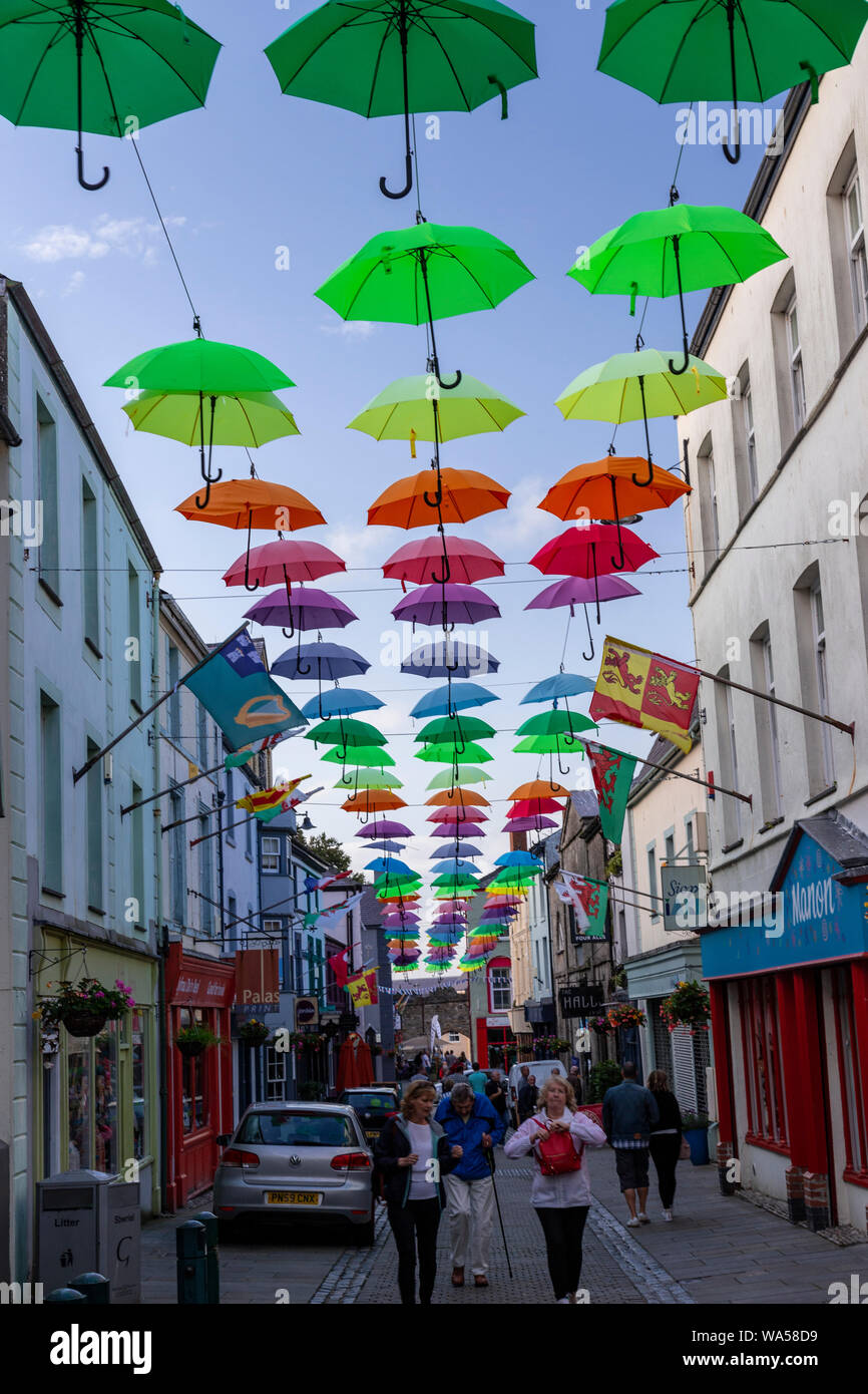 Multi-coloured umbrellas over Palace Street, Caernarfon, North Wales Stock Photo