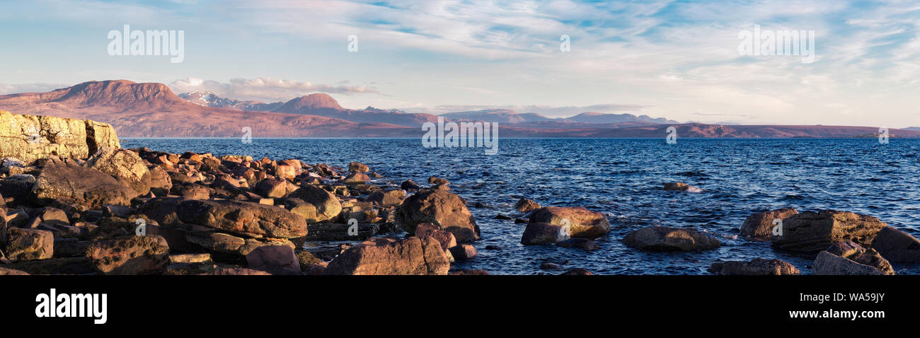 The warm evening glow across the cool waters of Loch Broom Stock Photo