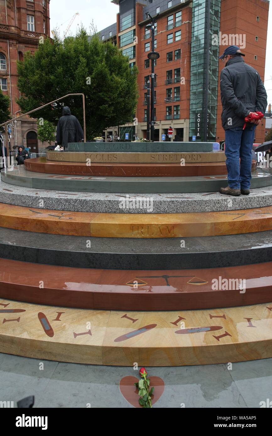 People gather together in Manchester in memory of the people that died ...
