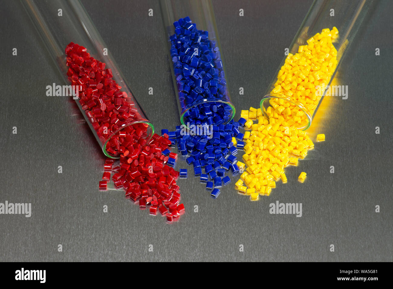 blue, red and yellow polymer resin in laboratory on metal plate Stock Photo