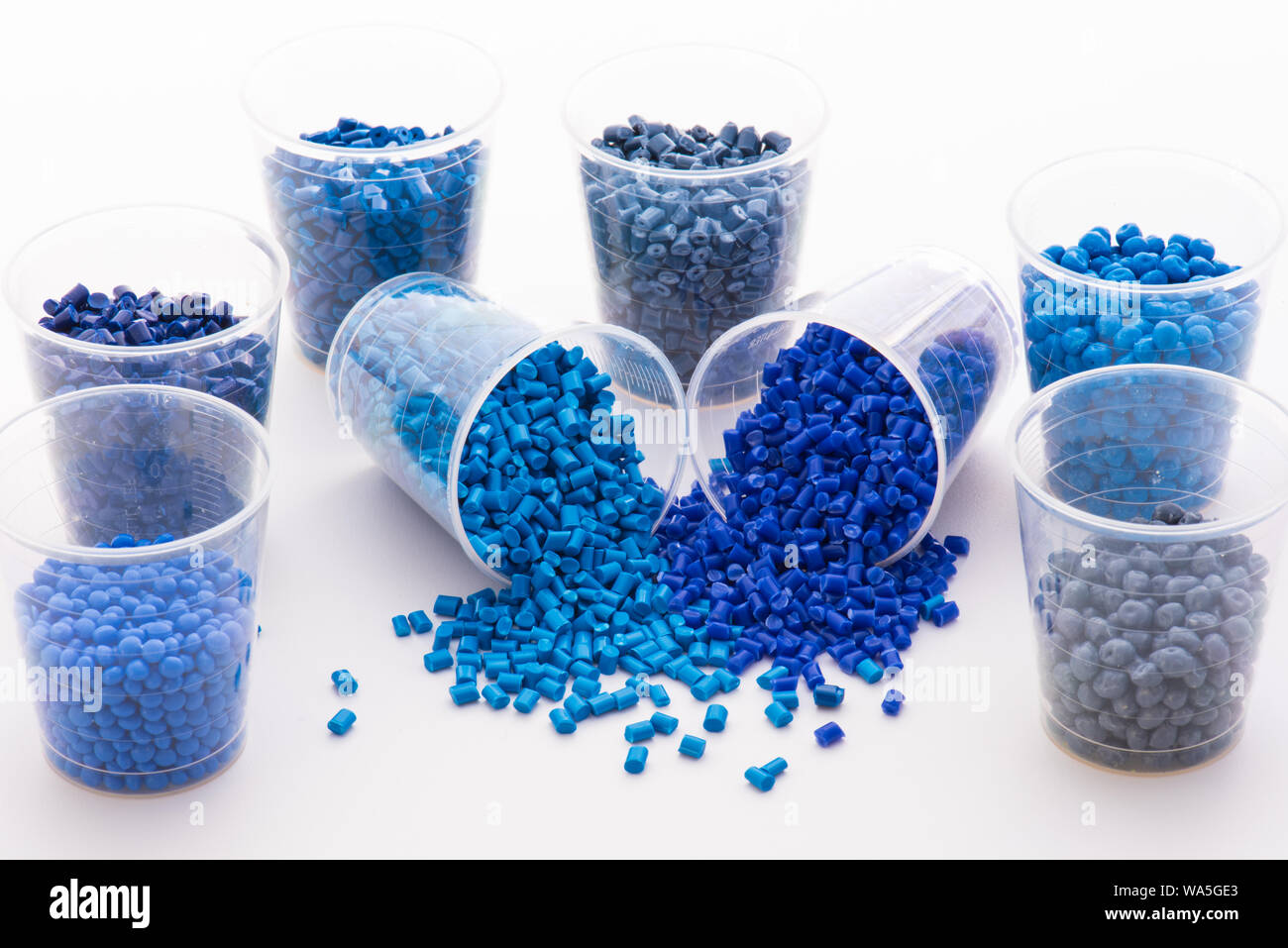 a variety of different colored blue polymer resins on white Stock Photo