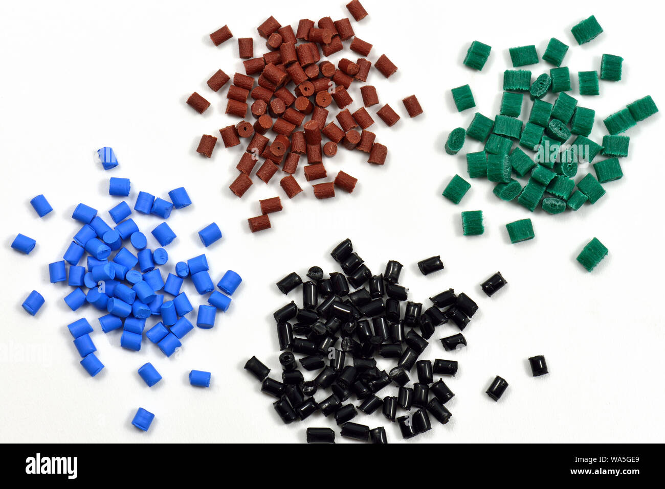 blue, brown, black, and green heaps of polymer resin for injection moulding in laboratory Stock Photo