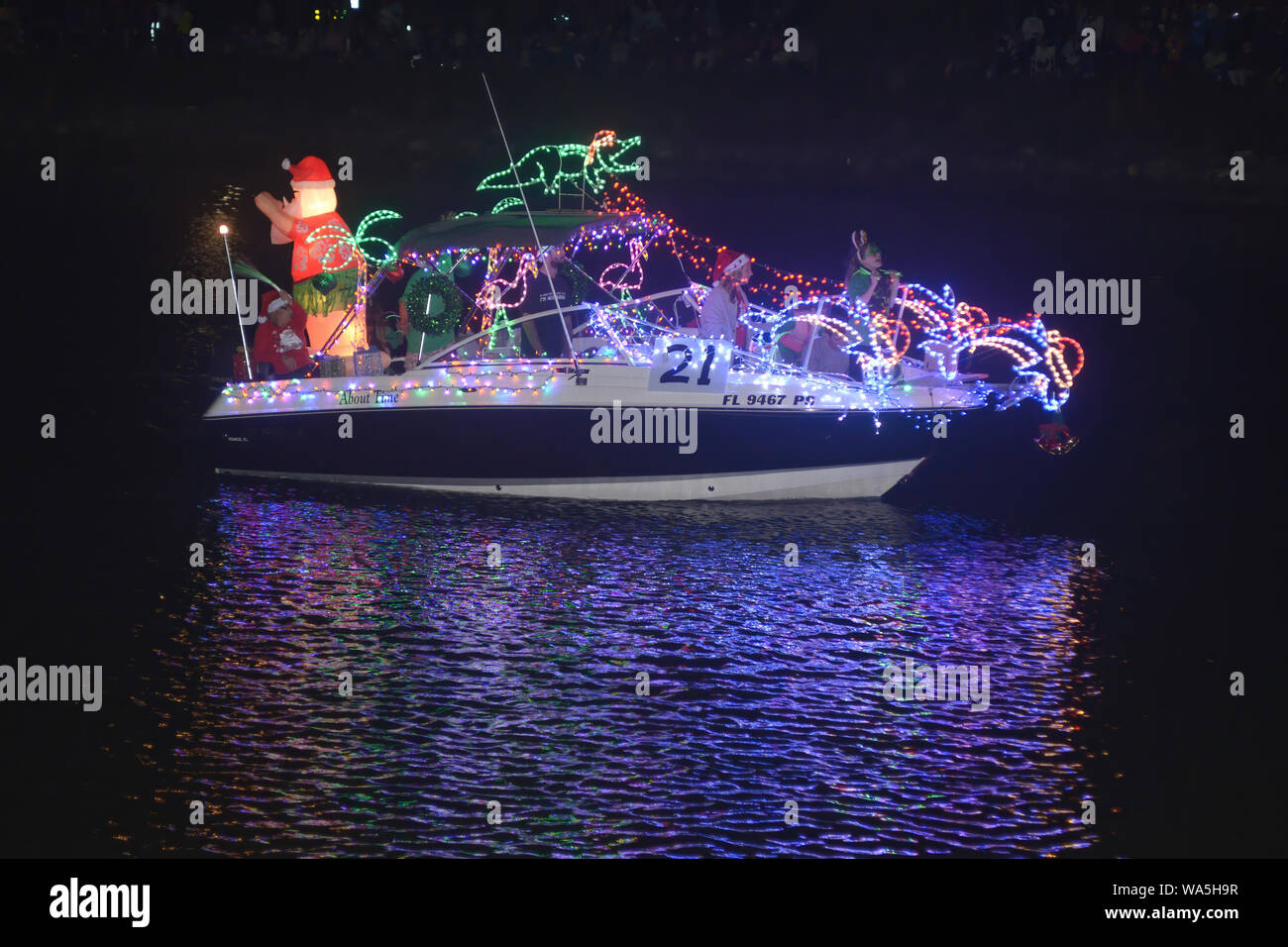 A boat carrying holiday revelers ride on a boat decorated in Christmas