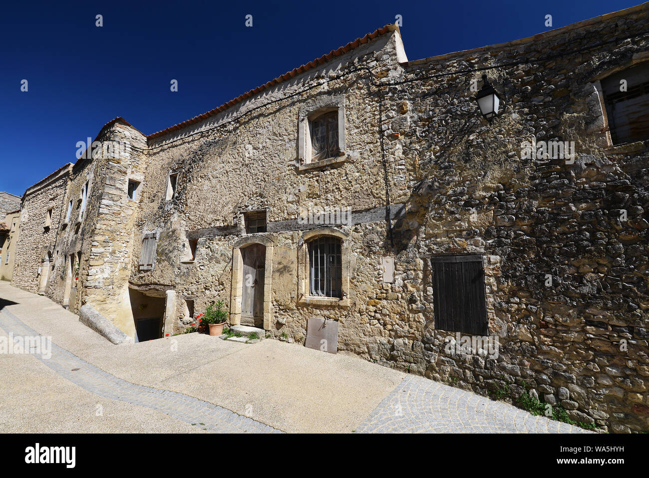 stony textured facade in little village in Provence, south France, in the sun. Stock Photo
