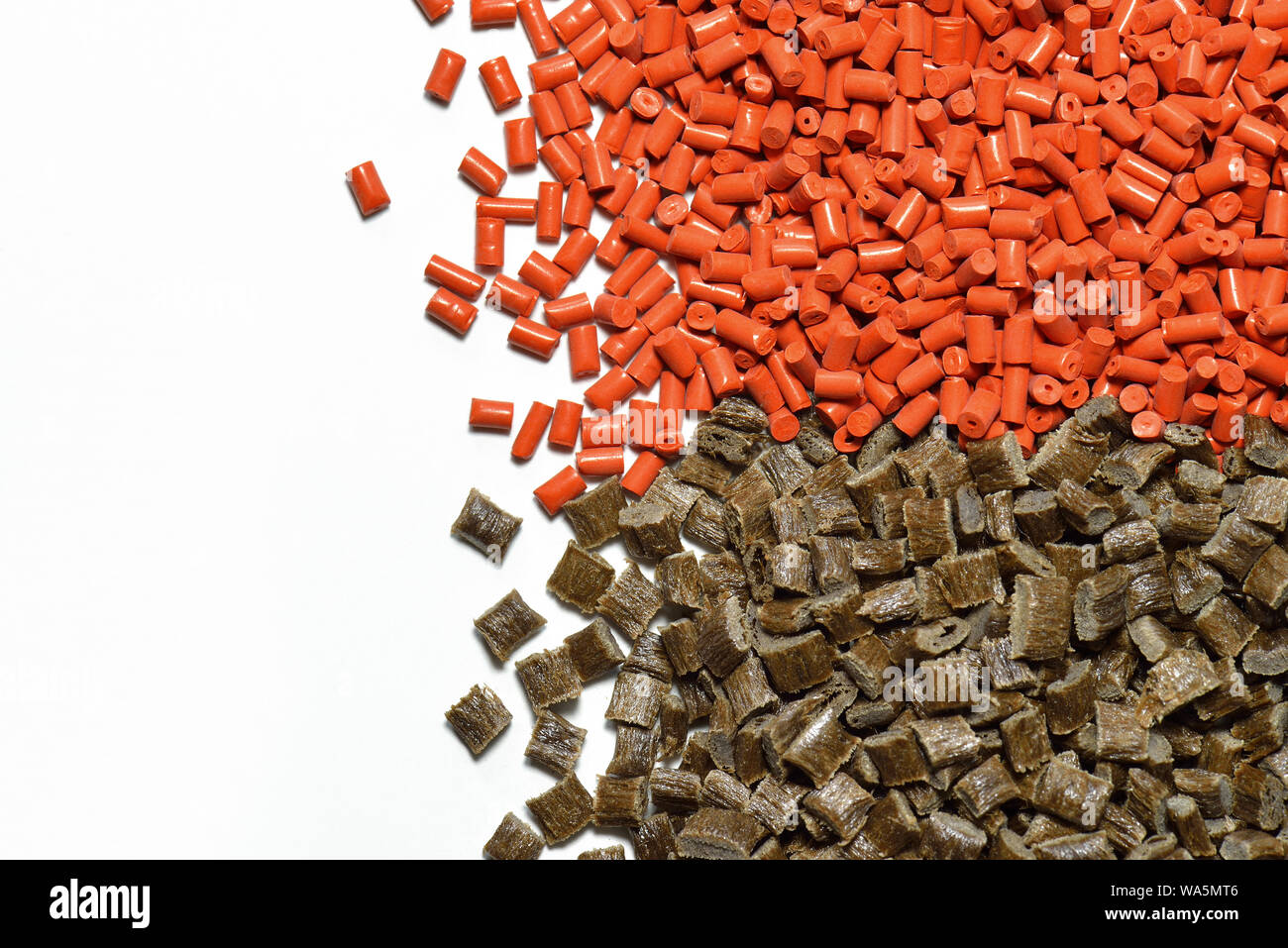 red and brown polymer resin. Pellets for injection moulding process in plastic industry. Stock Photo