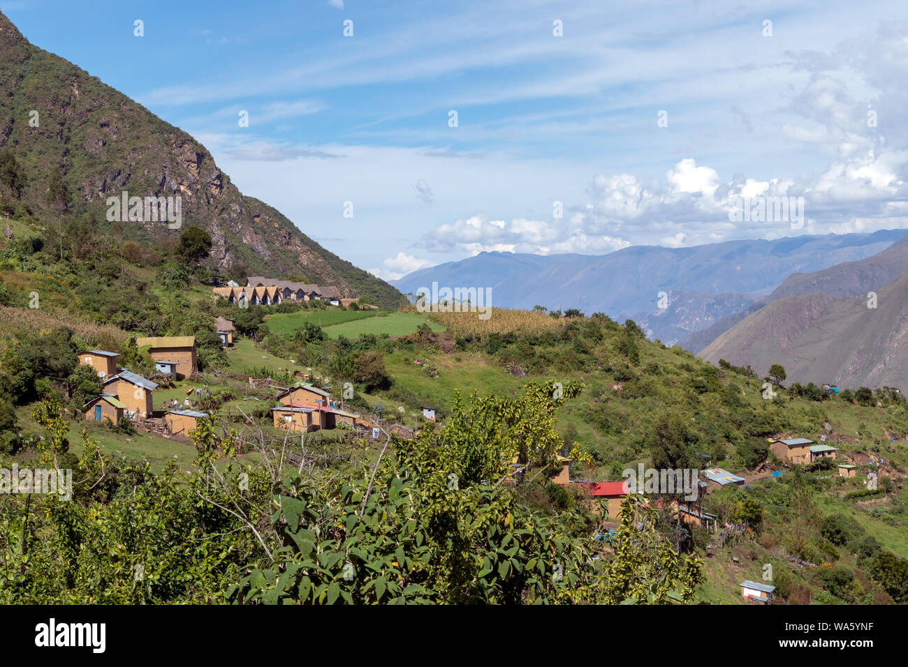 Village of Marampata at green Peruvian Andes mountains. The tiny settlement serves as the gateway to Choquequirao. Apurimac valley in the Willkapamba Stock Photo