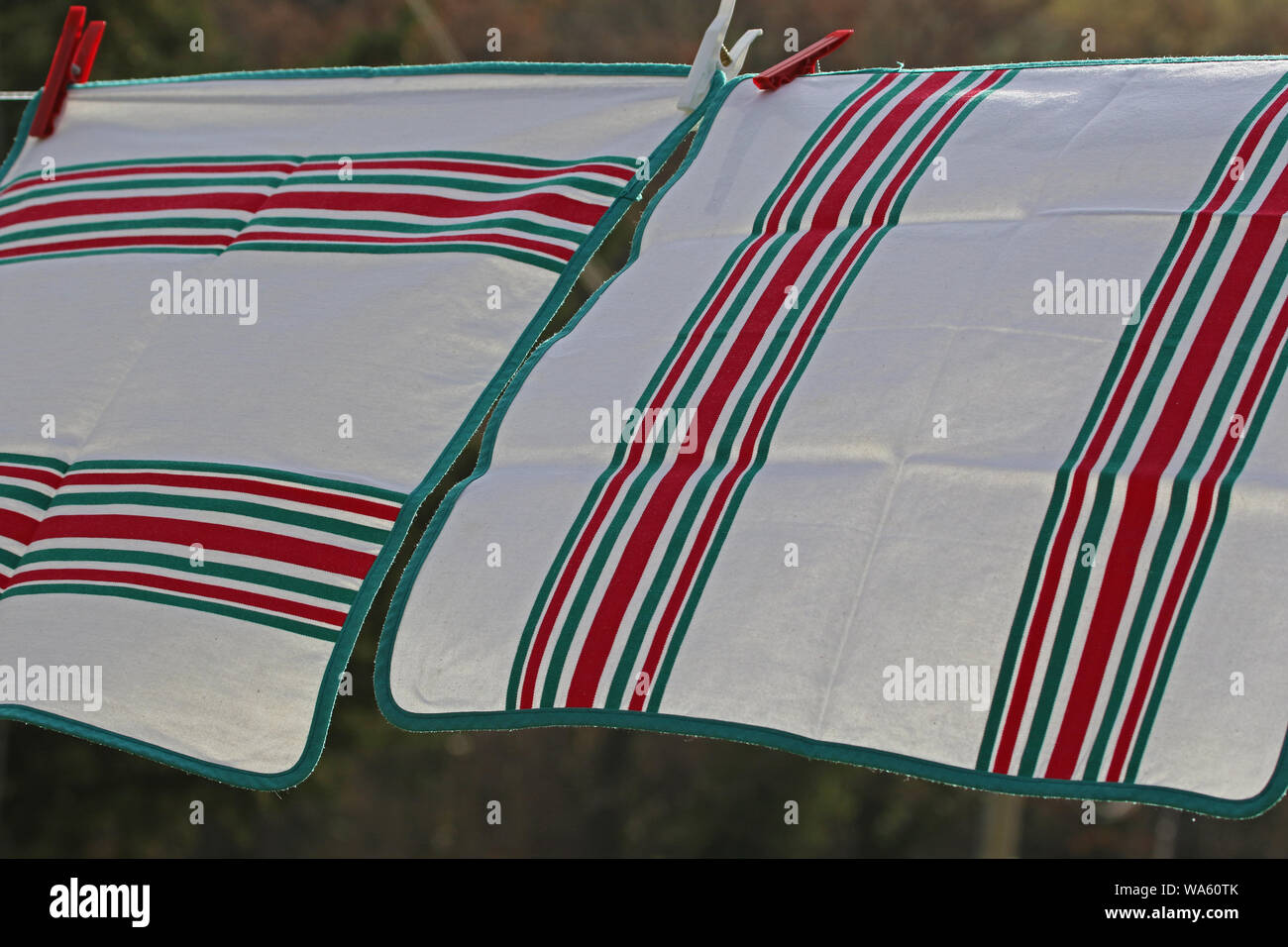 table napkins hanging out to dry on a breezy day in Italy showing traditional Italian colours