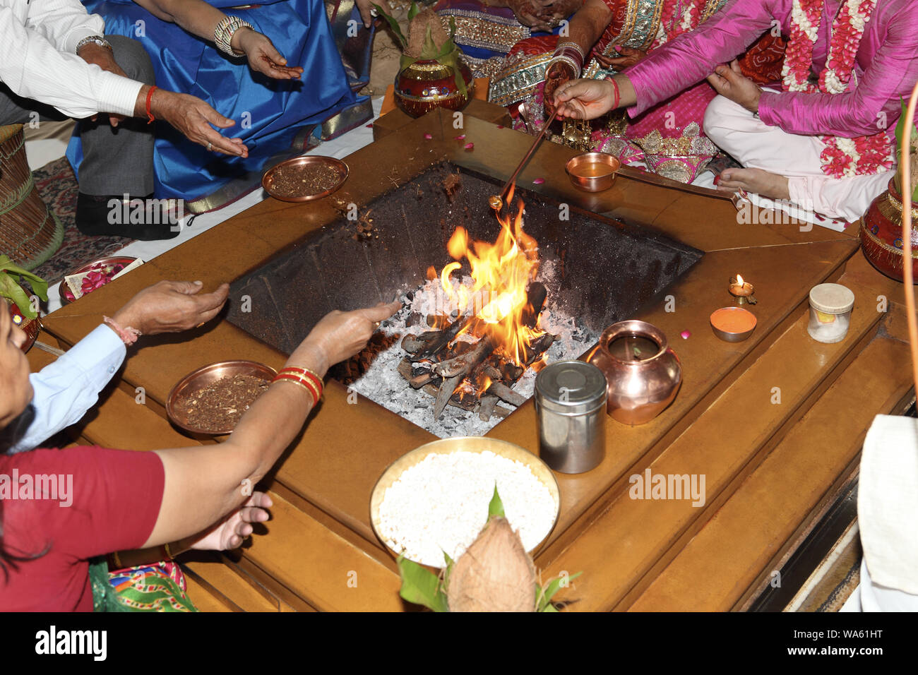 Newlywed couple performing traditional ritual in wedding ceremony Stock Photo