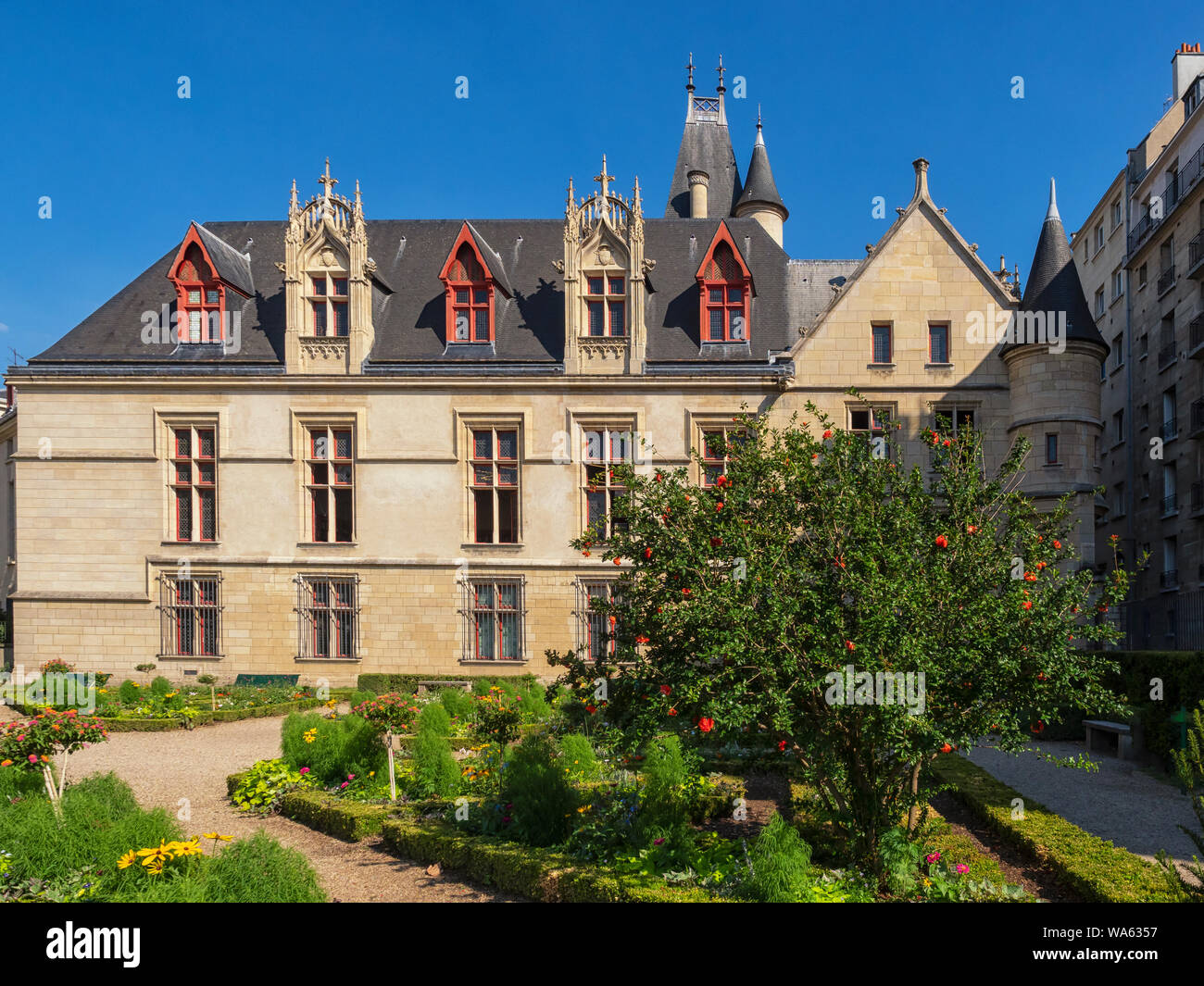 PARIS, FRANCE - AUGUST 02, 2018:   Hotel-de-Sens Garden and the rear of the Company Des Amis De La Bibliothèque Forney building Stock Photo