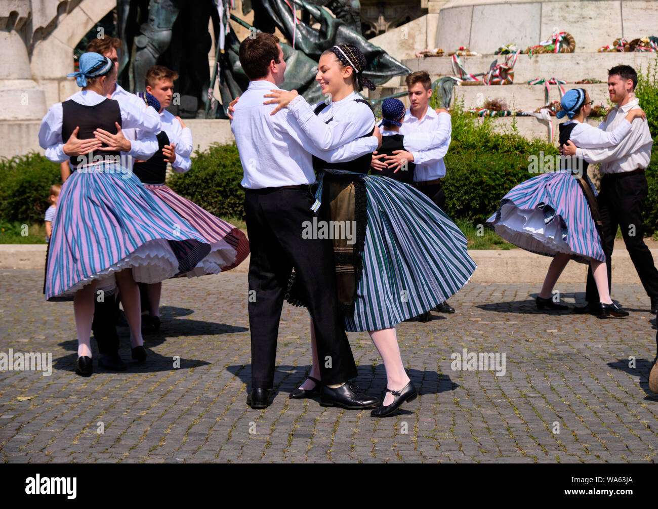 Hungarian Traditional dance troop in folkloric customs with a public performance in square. Couples dancing holding each other. Cluj, Romania, August Stock Photo