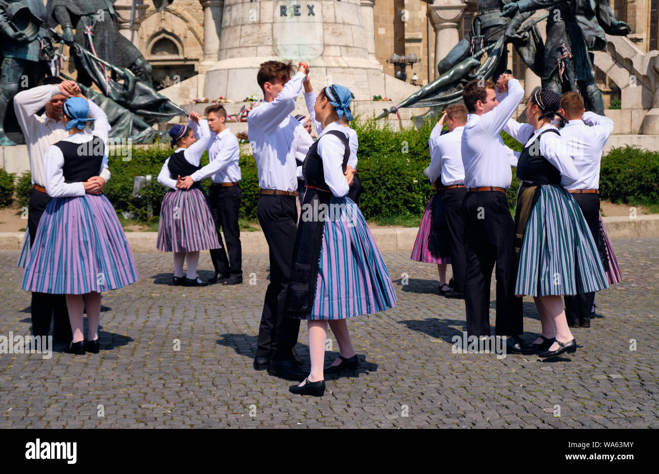 Hungarian Traditional dance troop in folkloric customs with a public performance in square. Dancer performing in pairs, man leading.  Cluj, Romania, Stock Photo