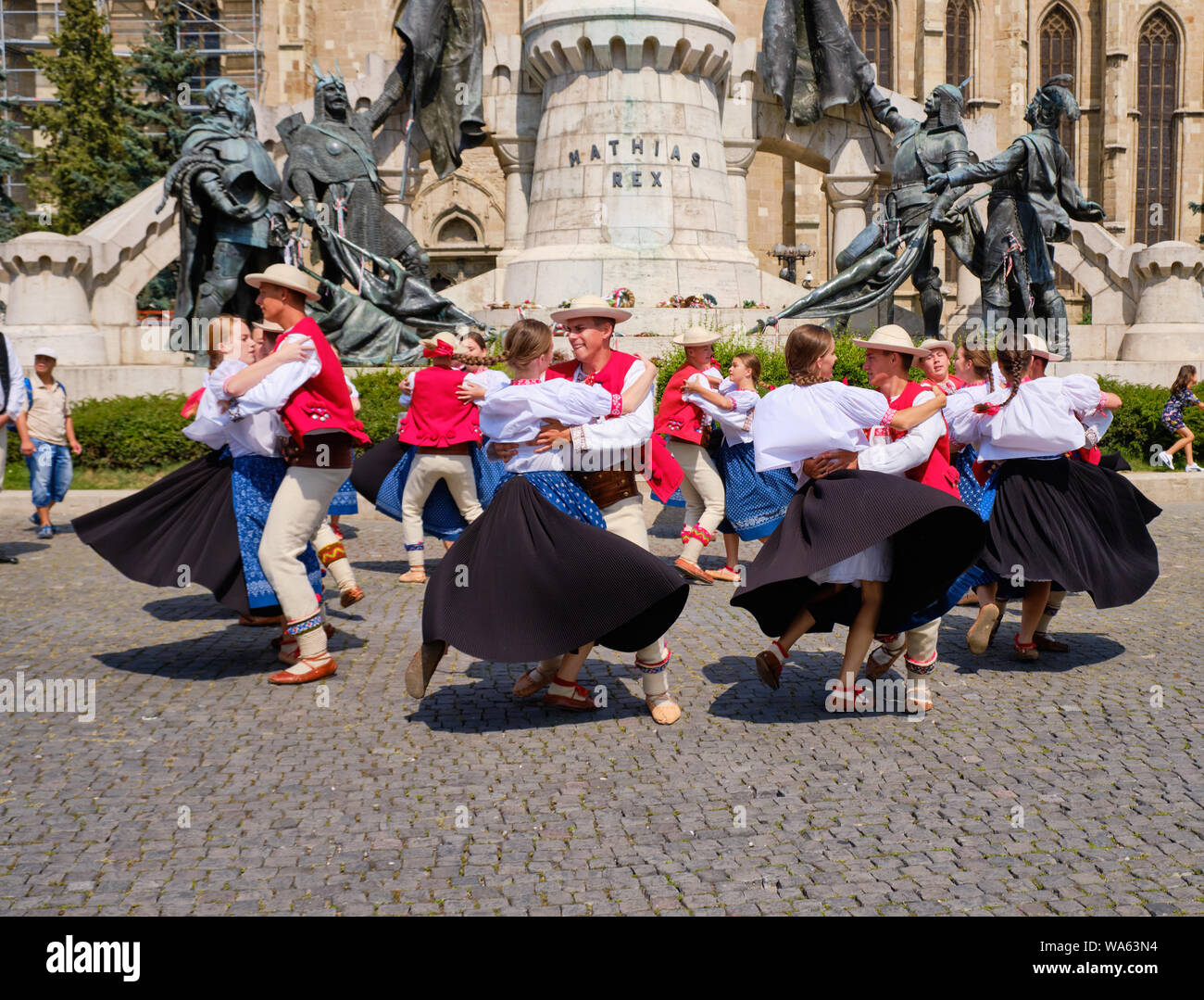 Polish Traditional dance troop in folkloric customs with a public performance in square.  Couples dancing holding each other, man spinning ladies Stock Photo