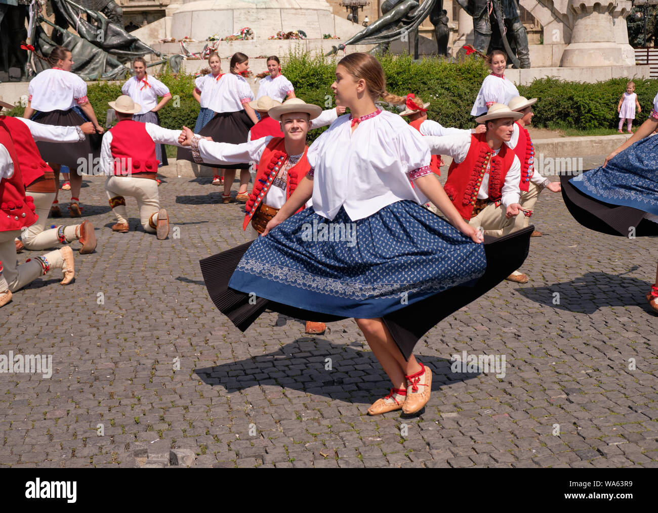 Polish Traditional dance troop in folkloric customs with a public performance in square. Couple number, with man pleading lady.   Cluj, Romania, Stock Photo