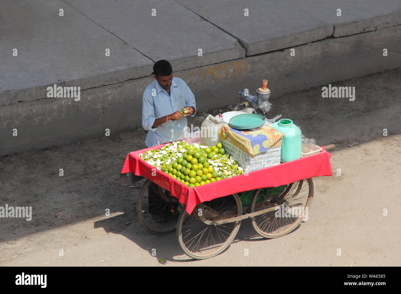 Vendor selling mausami juice at a market stall Stock Photo