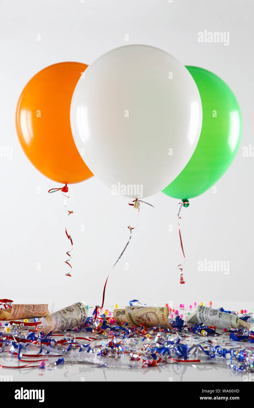 Indian banknotes hanging with tricolor balloons representing growth of 'India' Stock Photo