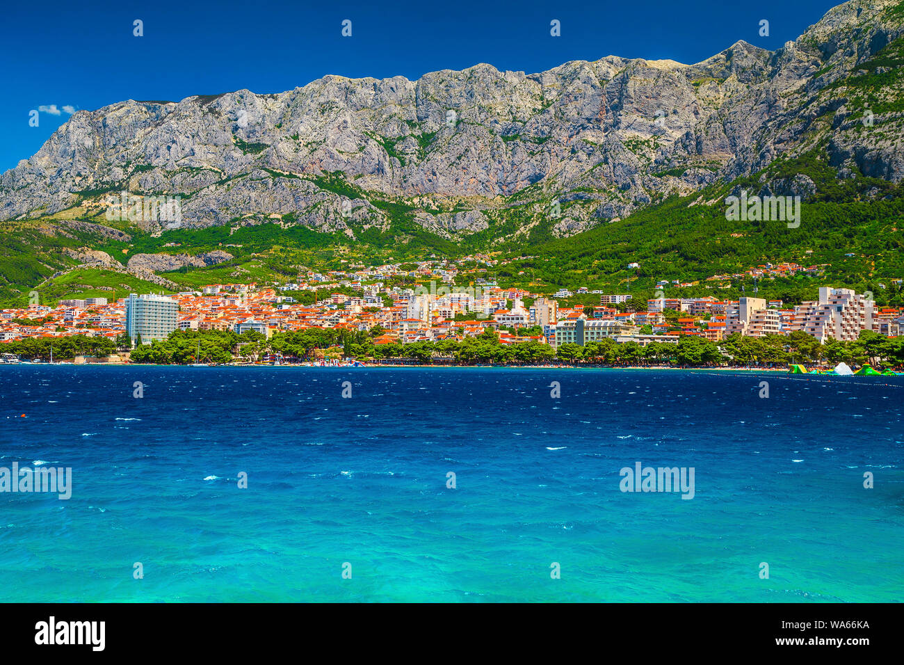 Amazing summer vacation resort, Makarska cityscape with mountains, sea and spectacular beach. Wonderful Adriatic resort with blue sea, Makarska rivier Stock Photo