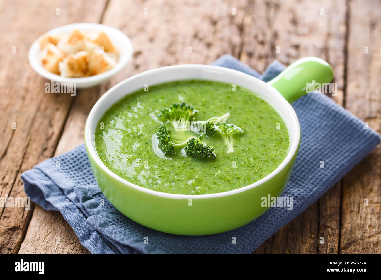 Fresh homemade cream of broccoli soup in bowl garnished with broccoli ...