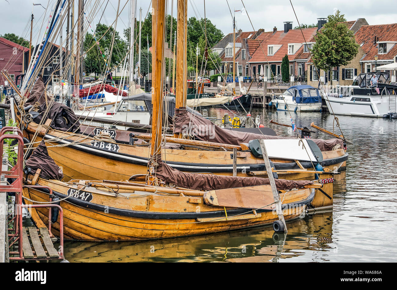 Elburg, The Netherlands, August 3, 2019: historic wooden fishing boats in the old town's harbour Stock Photo