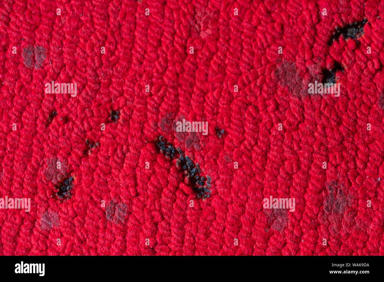 incense and candle burn marks on red carpet Stock Photo Alamy