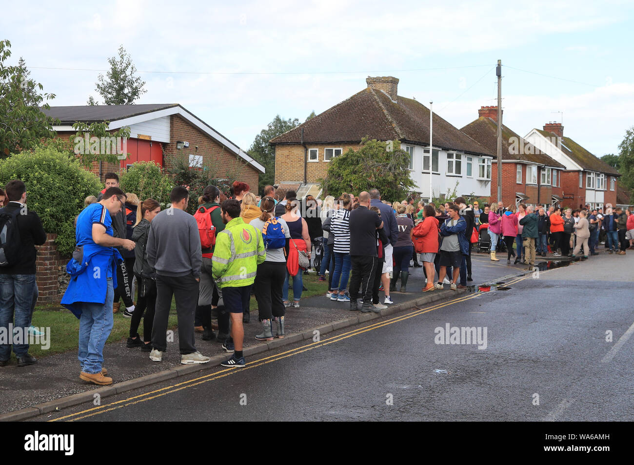 Members of the public gather to join specialist search and rescue teams outside the fire station in Sandwich, Kent as they prepare to resume the search for a missing six-year-old boy who fell into the River Stour in Sandwich, on Saturday afternoon. Stock Photo