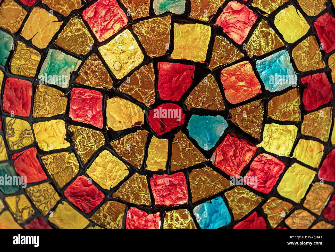 Stained glass mosaic on the lampshade of the chandelier. Stock Photo