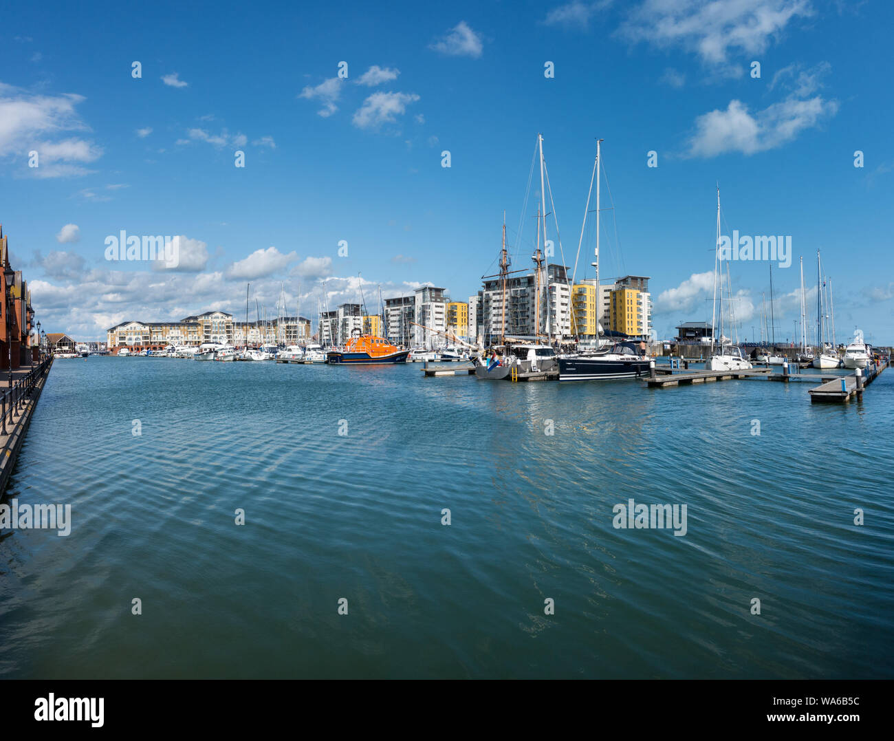 Waterside apartments and moored boats, Sovereign Harbour, Eastbourne, East Sussex, England,UK Stock Photo