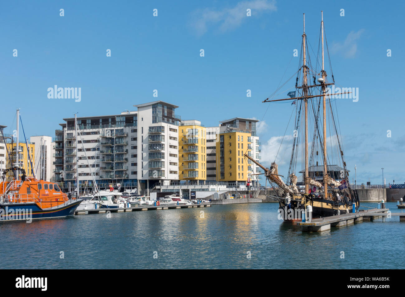 The old and the new; A tallship moored in Sovereign Harbour, Eastbourne, East Sussex, England, UK Stock Photo