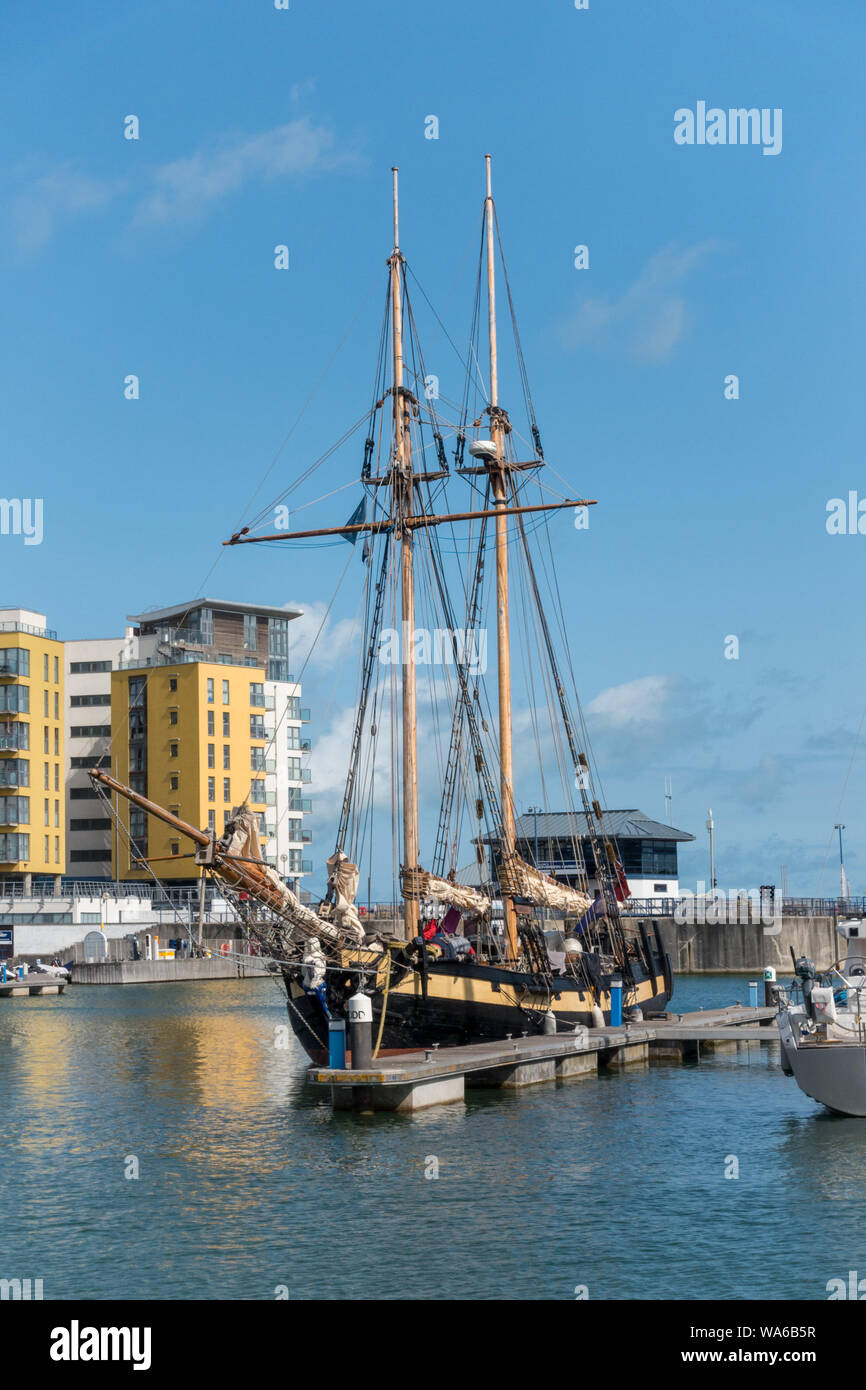 The old and the new; A tallship moored in Sovereign Harbour, Eastbourne, East Sussex, England, UK Stock Photo