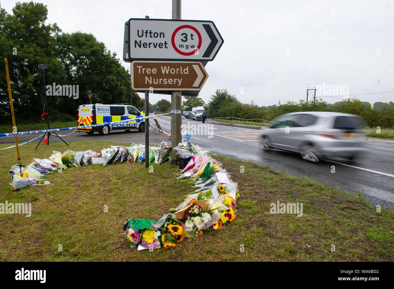 Police and flowers left at the scene where Thames Valley Police officer Pc Andrew Harper, 28, died following a 'serious incident' at about 11.30pm on Thursday near the A4 Bath Road, between Reading and Newbury, at the village of Sulhamstead in Berkshire. Stock Photo