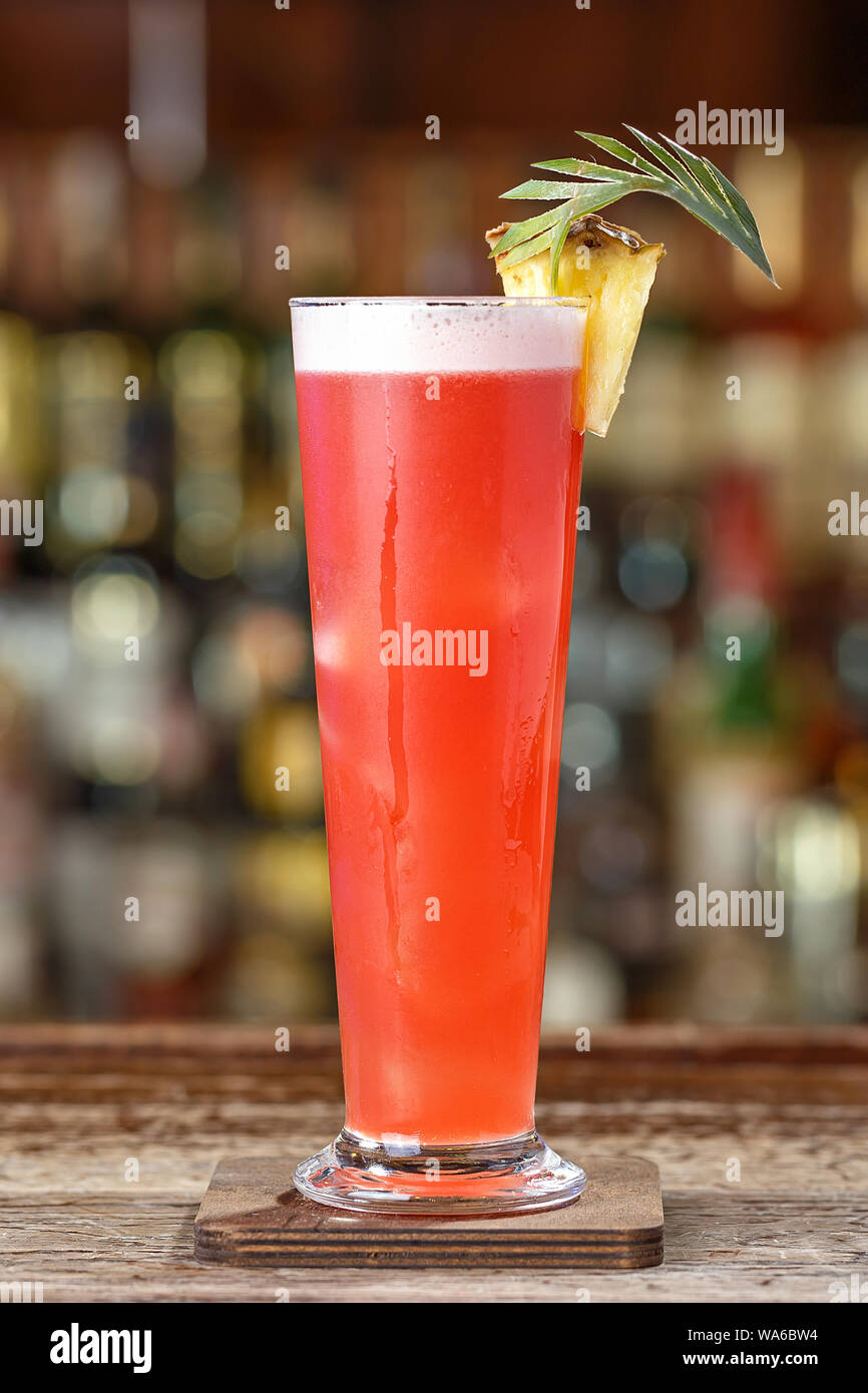 Singapore sling cocktail with gin, cherry and orange liqueur Benedict,  grenadine, pineapple and lemon juice with the addition of bitter Angostura  Stock Photo - Alamy