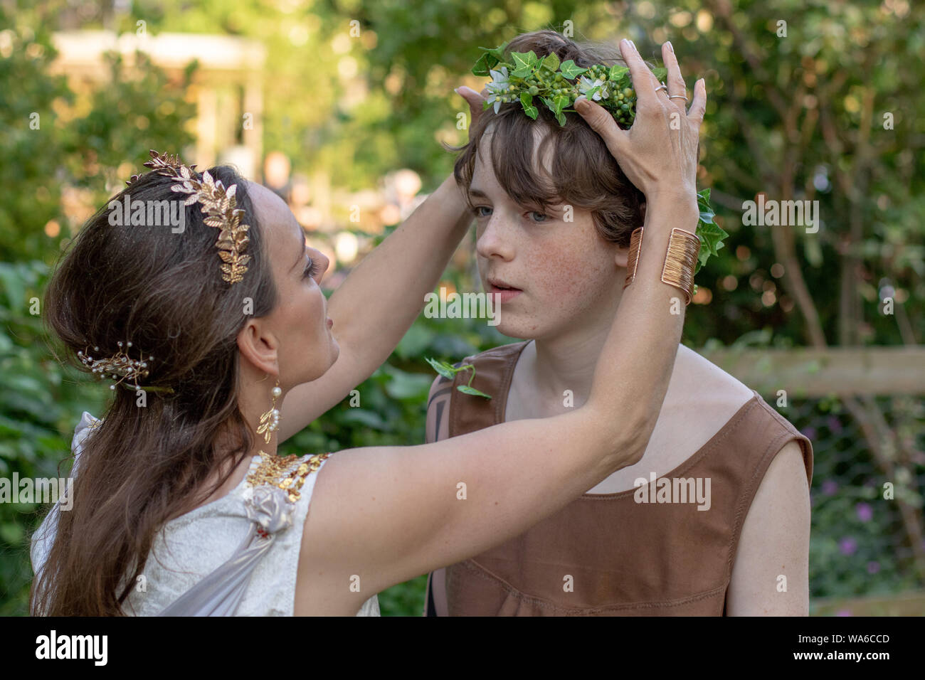 Titania Queen of the Fairies adjusting First Fairy' wreath Stock Photo