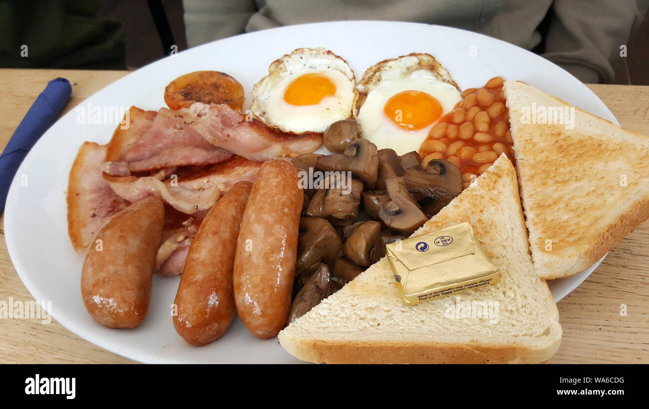 traditional full English breakfast on a white plate Stock Photo