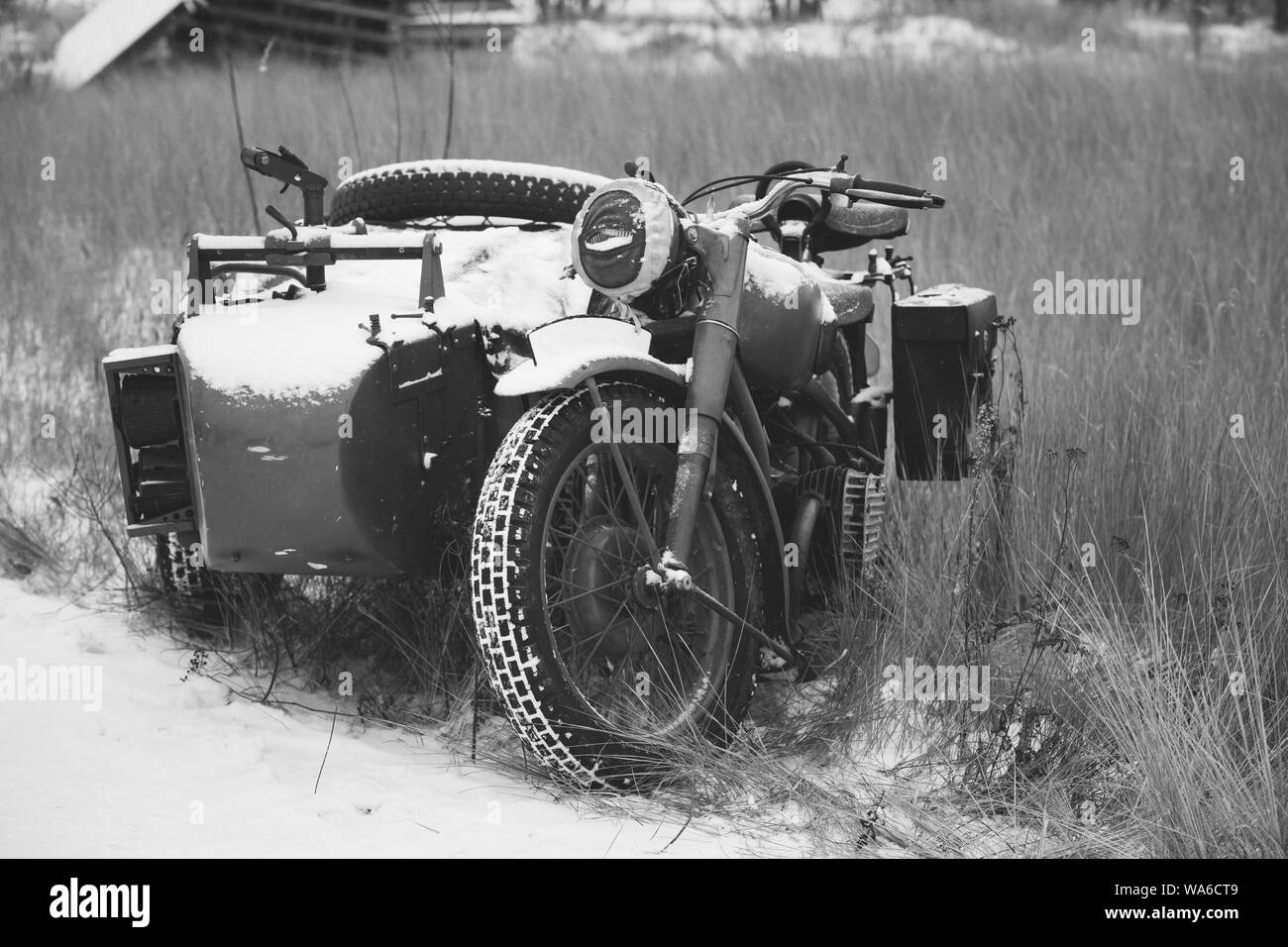 Old Tricar, Three-Wheeled Motorbike Of Wehrmacht, Armed Forces Of Germany Of World War II Time In Winter Forest. Photo In Black And White Colors. Stock Photo