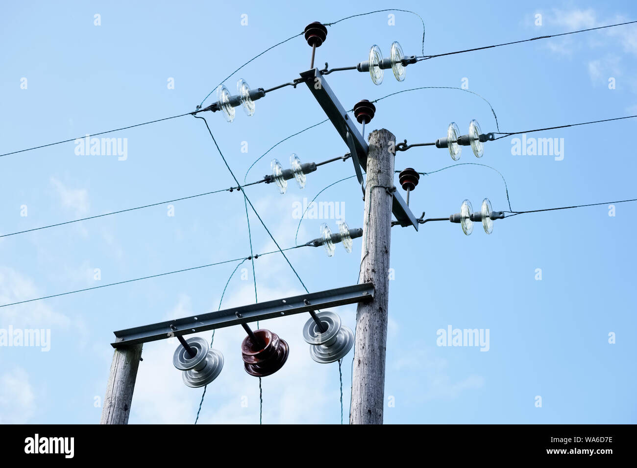 Overhead electrical line telephone cables wires danger electricity kills blue sky background