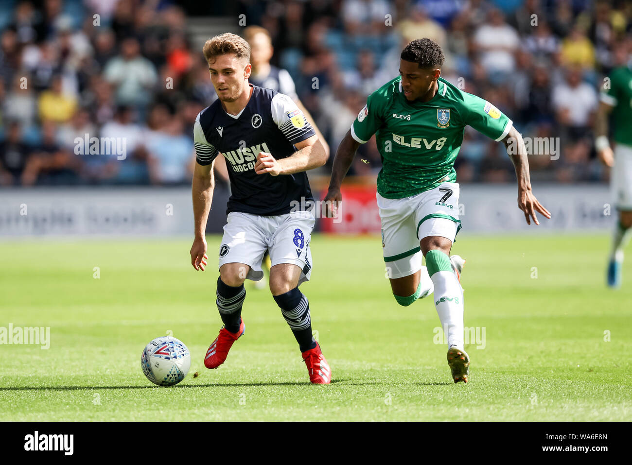 Ben Thompson of Millwall is challenged by Kadeem Harris of Sheffield Wednesday during the EFL Sky Bet Championship match between Millwall and Sheffield Wednesday at The Den, London, England on 17 August 2019. Photo by Ken Sparks.  Editorial use only, license required for commercial use. No use in betting, games or a single club/league/player publications. Stock Photo