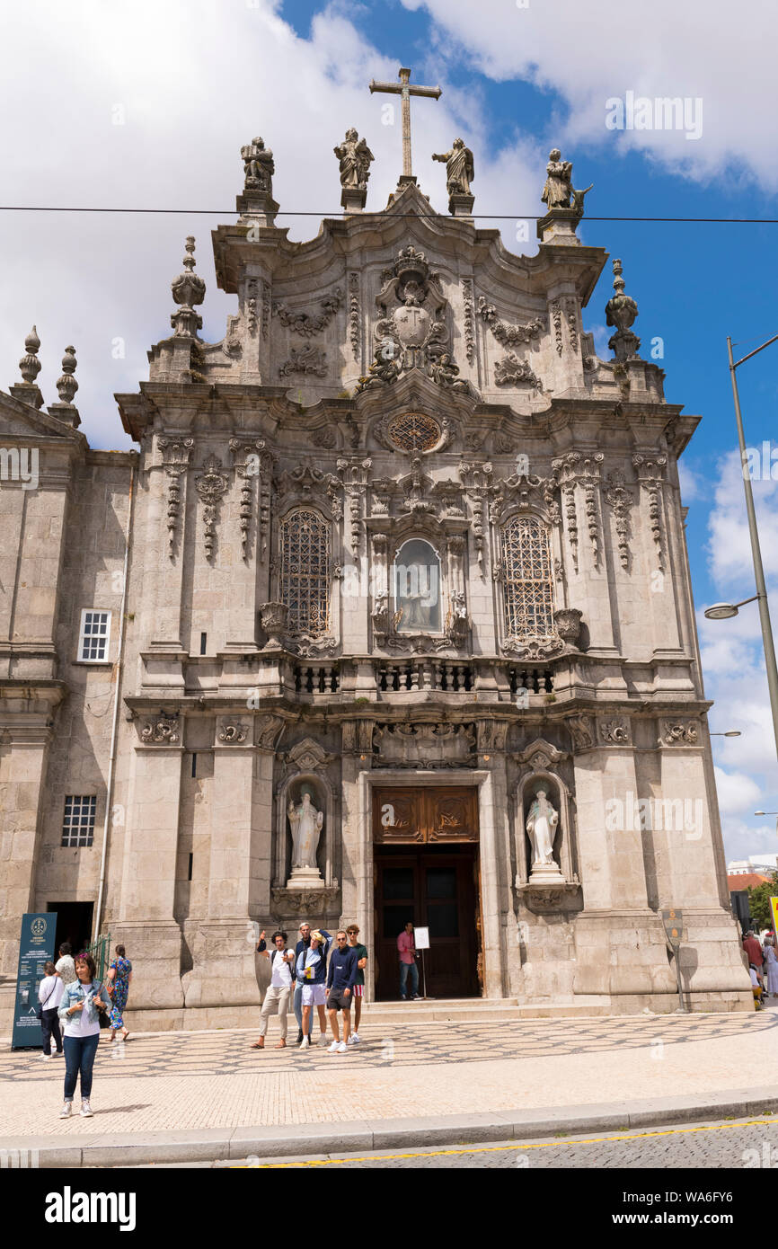 Portugal Oporto Porto Igreja do Carmo Church built 1768 facade narrowest house 1 metre wide clouds cross stone statues sculptures Stock Photo