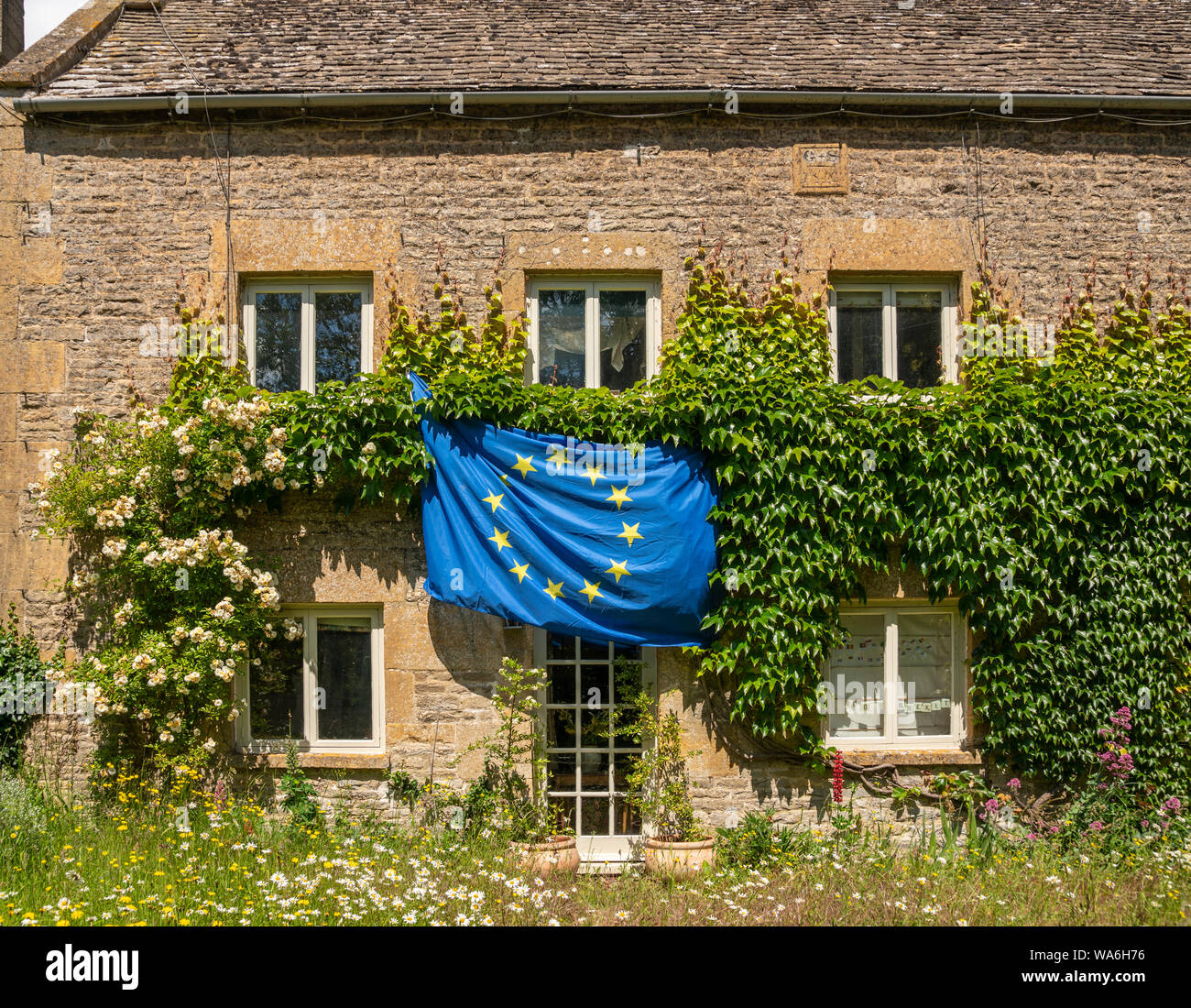 EU flag outside cottage in Naunton, Gloucestershire, United Kingdom Stock Photo