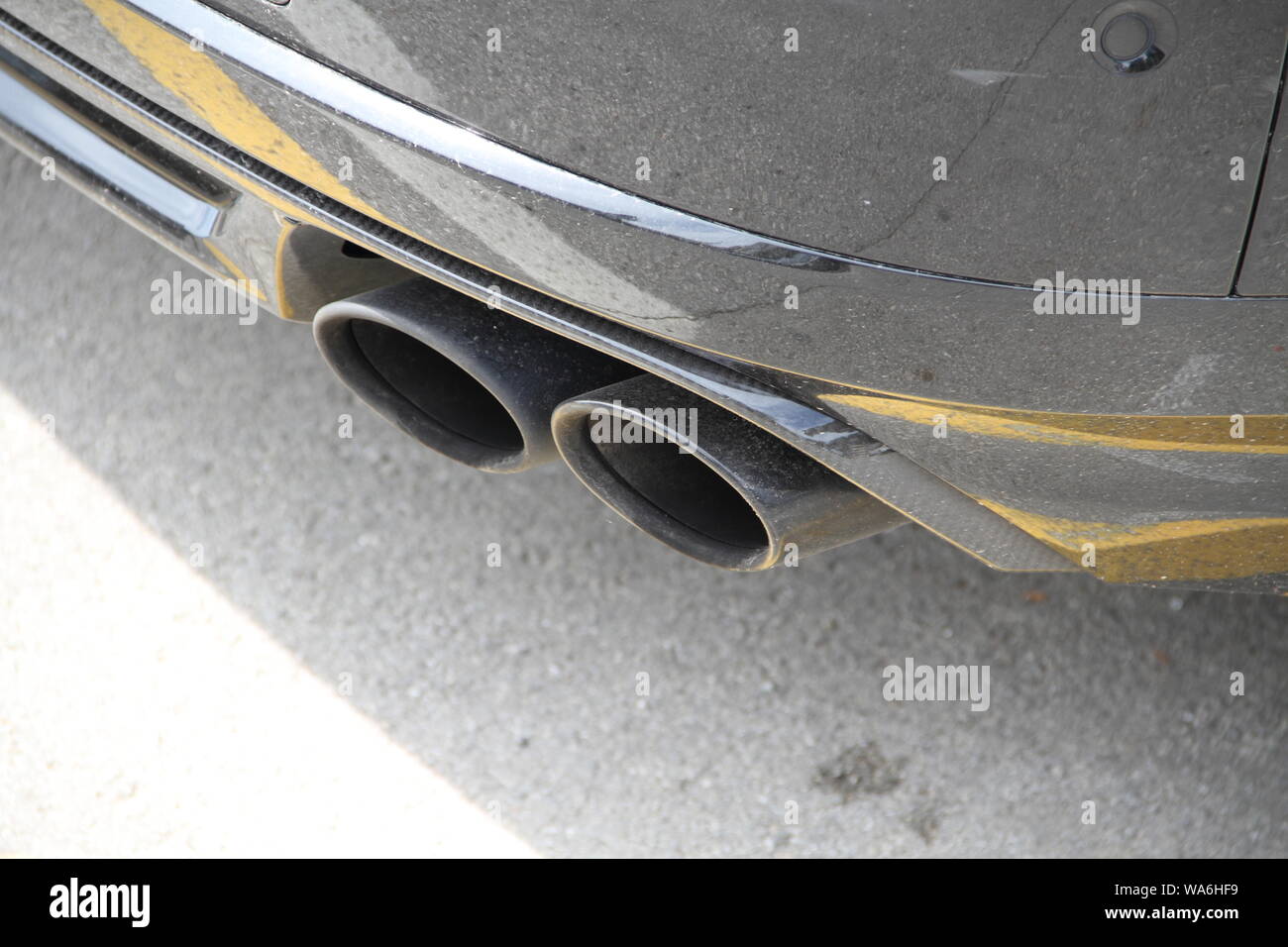 Double exhaust of a black car Stock Photo Alamy