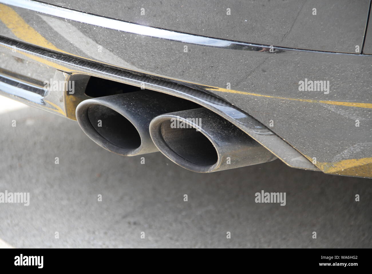 Double exhaust of a black car Stock Photo - Alamy