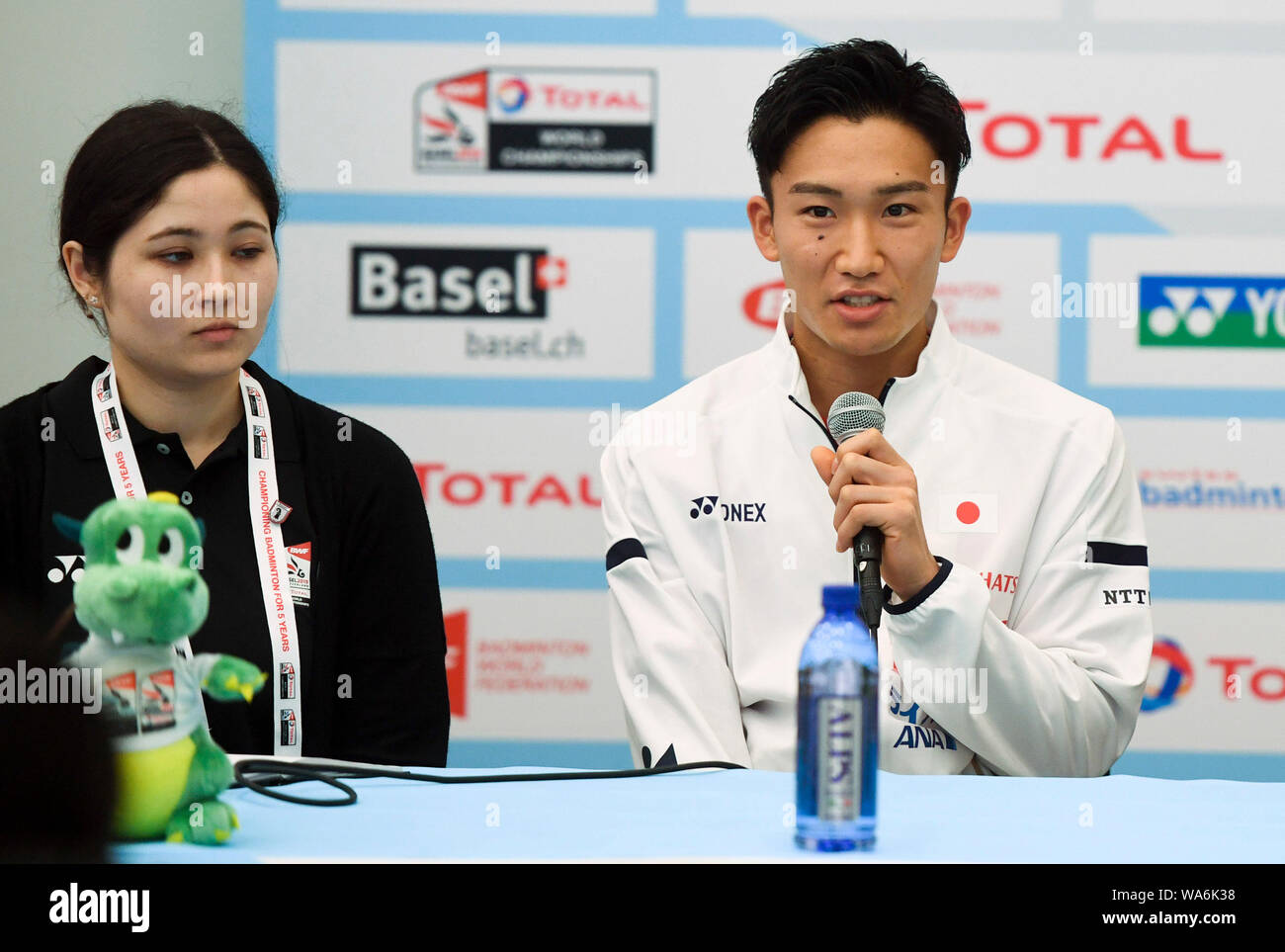 Basel, Switzerland. 18 August 2019. Kento Momota (R) of Japan speaks during the pre-match press conference of 2019 BWF World Championships . Credit: Xinhua/Alamy Live News Stock Photo