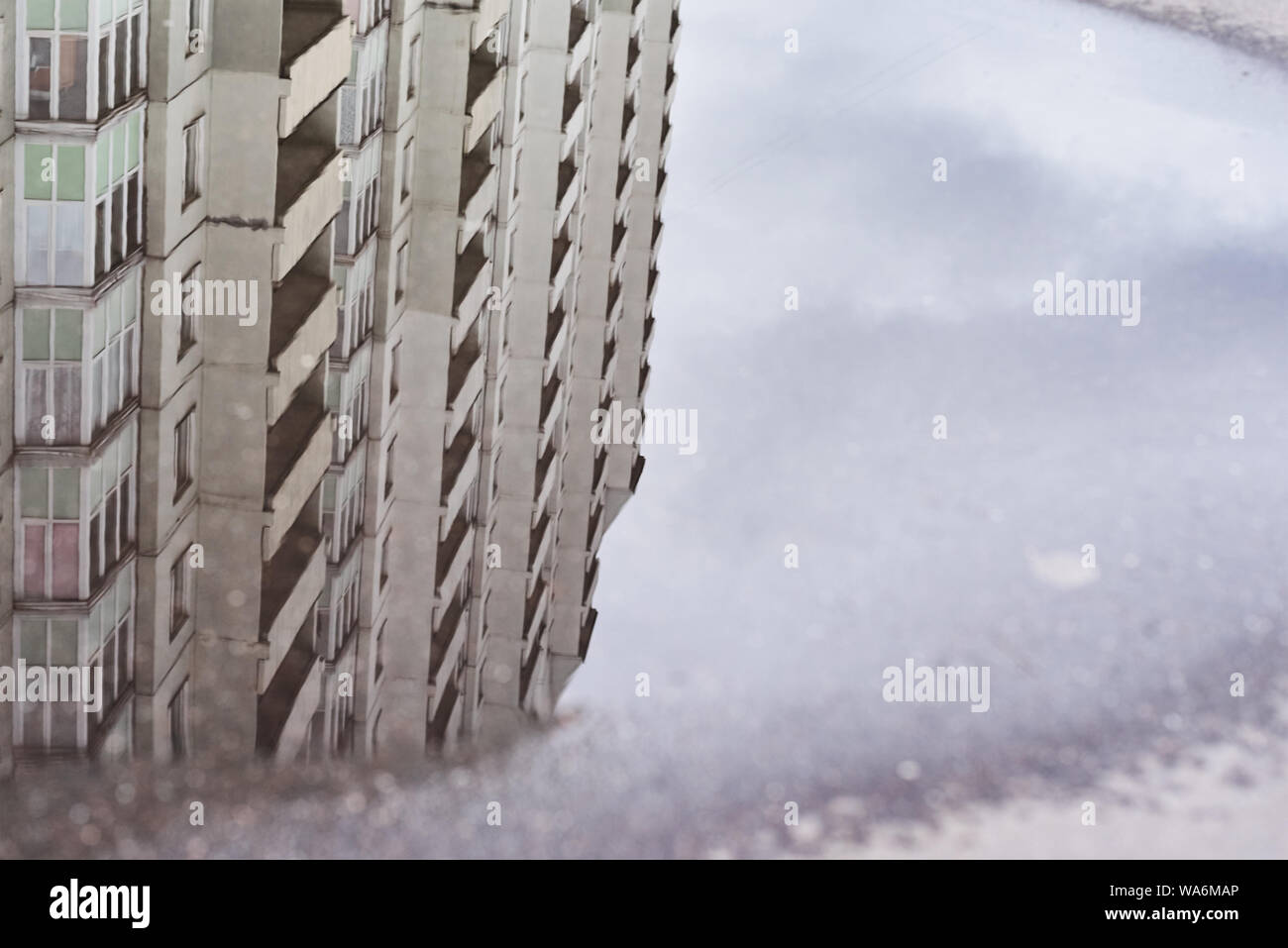 Buildings reflection in puddle at city street Stock Photo - Alamy