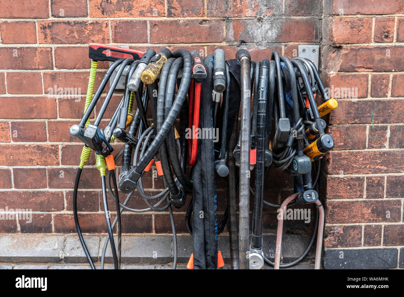 Bicycle locks hanging on rail at cycle park outside Waterloo station